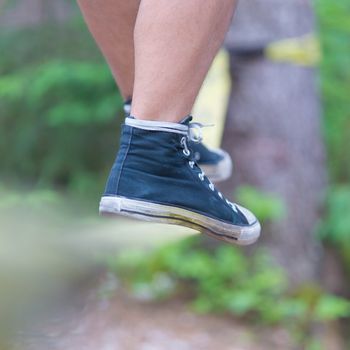 Slacklining is a practice in balance that typically uses nylon or polyester webbing tensioned between two anchor points.