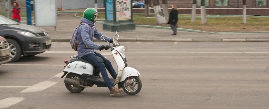 The driver of the scooter on the street in Moscow