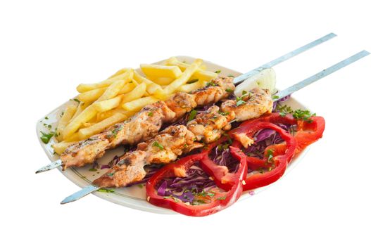 shish kebab on skewers with chips and red pepper pickled cabbage