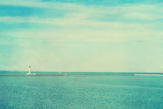 Vintage photo of lighthouse tower. Nautical texture background with a lighthouse for the retro concept of sea vacation.
