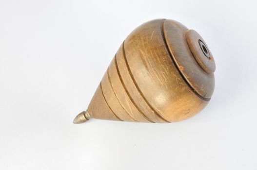 Wooden top with iron tip. Spin by throwing a string coiled around it.