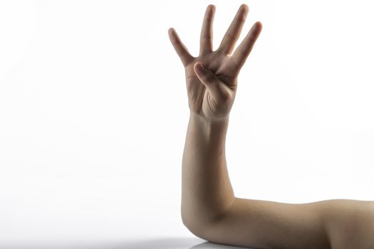 Young hands makes a gesture: number four sign with 4 fingers