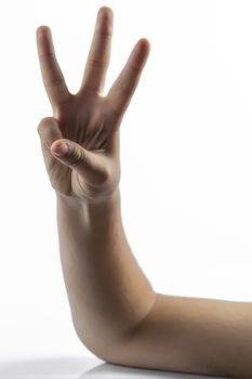 Young hands makes a gesture: number three sign with 3 fingers