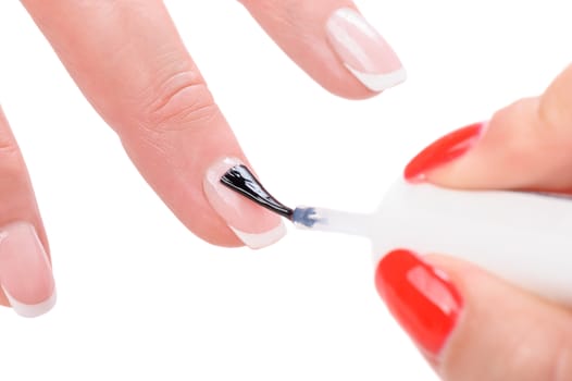 manicure applying, brushing fingernails with clear enamel