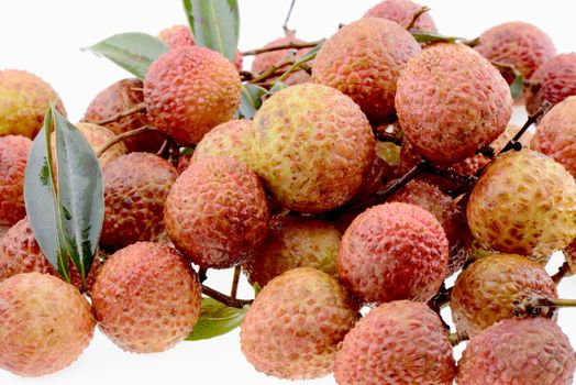 Pile of Fresh lychee fruits on a white background