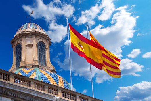 Detail of Palau de la generalitat de Catalunya in Barcelona, Spain with Spanish and Catalan flag waving in the wind
