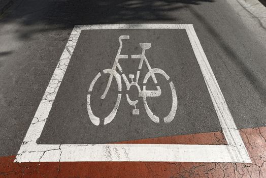Red and white markings representing a bicycle in a route reserved for bikes in Barcelona, Spain