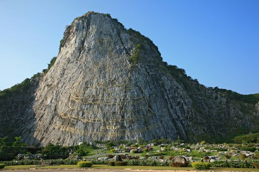 Carved buddha image on the cliff at Khao Chee Jan, Pattaya, Thailand