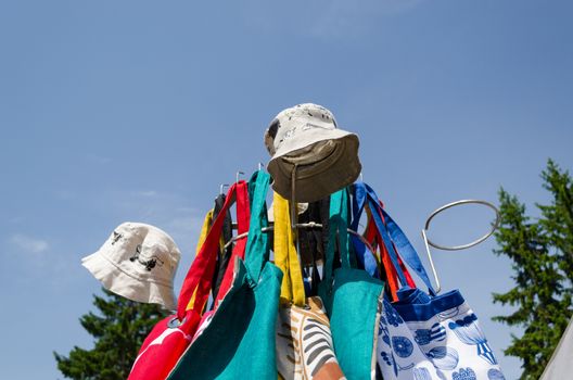 linen hand sew caps and bag on the fair stand on blue sky background