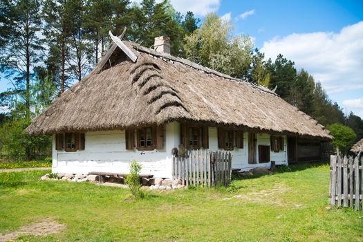 Old rural house with thatched roof near Bialystok, Poland