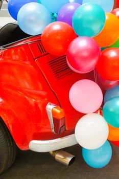 red minicar and colorful balloon,shallow focus