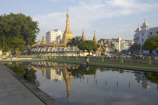 Yangon, Myanmar-May 8th 2014: Sule Pagoda reflected a pond. The pagoda is considered to be the centre of Yangon and the point from which distances to other places are measured.