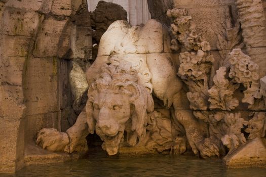 Lion statue - detail on the Poseidon statue, Piazza Navona, Rome, Italy