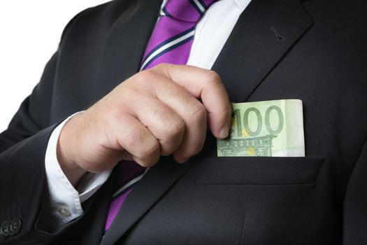 Businessman in dark suit and with tie putting money in his pocket