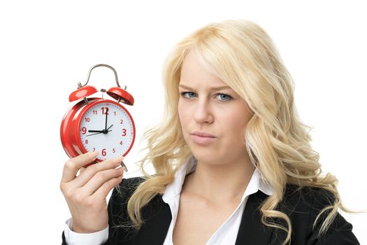 Laughing blond woman unhappy with red alarm clock