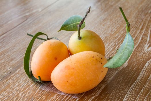 Plum mango, or Marian plum fruit on wooden table