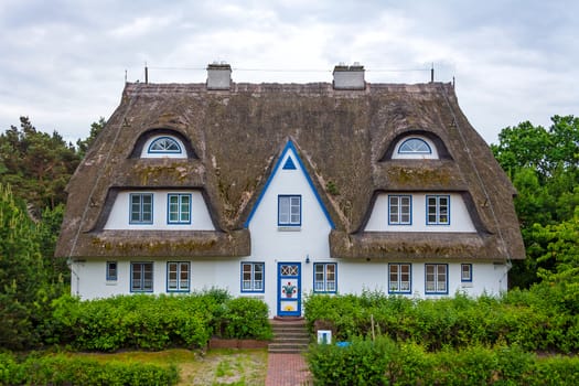 thatched-roof guesthouse with holiday apartments