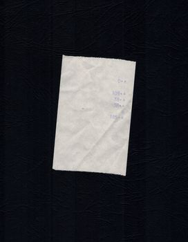 bill or receipt isolated over black background