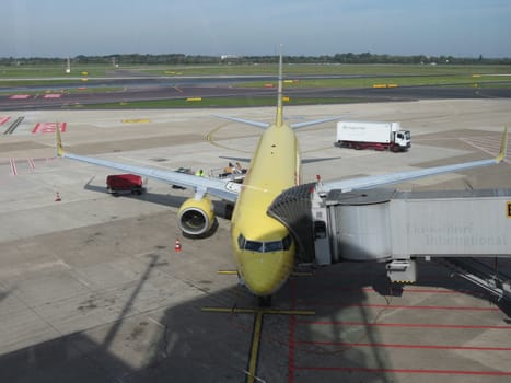 DUESSELDORF (GERMANY), CIRCA OCTOBER 2013: airplane of the DHL mail company parked at the airport ready for boarding, in Duesseldorf, October 2013 