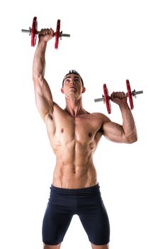 Muscular sexy shirtless young man exercising shoulders with dumbbells, isolated on white 