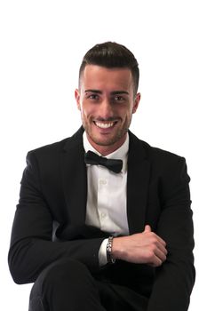 Handsome young man with suit and bowtie isolated on white, looking at camera