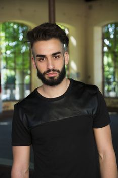 Handsome young man with beard looking at camera