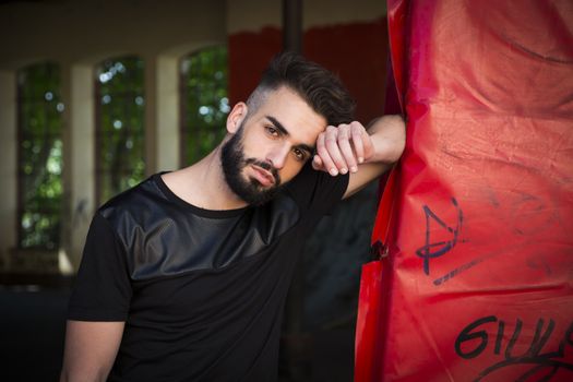 Handsome young man with beard looking at camera