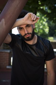 Handsome young man with beard looking at camera