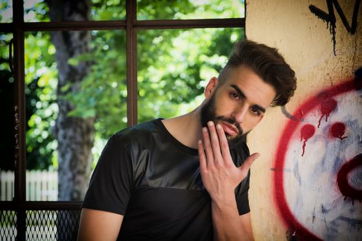 Handsome young man with beard looking at camera