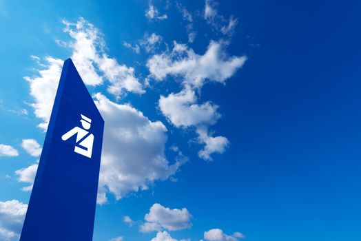 Blue billboard with symbol of police on blue sky with clouds - Barceloneta beach in Barcelona, Spain