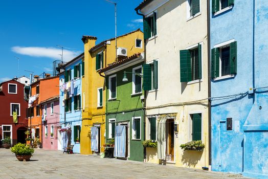 Colorful buildings in Burano island sunny street, Venise, Italy