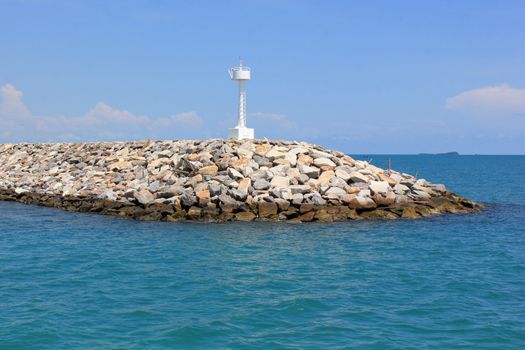 lighthouse on island with blue sky