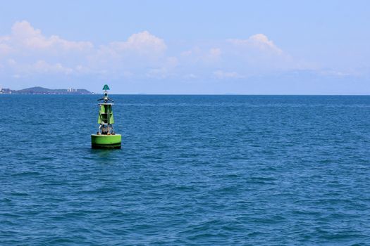 a buoy in the sea with blue sky