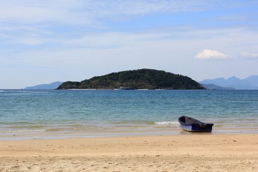 plastic boat on the beach with blue sky