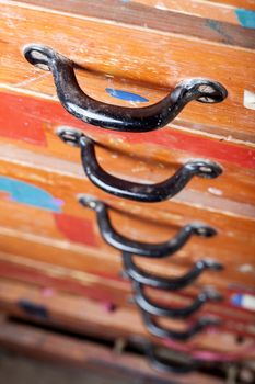 old chest of drawers with black handles in closeup