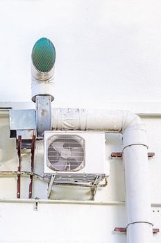 Compressor of air condition and exhaust ventilation pipe are set behind the building 