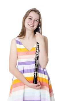 smiling girl in colorful dress with oboe against white background
