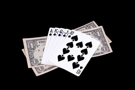 Flush royal cards with money isolated on black background 