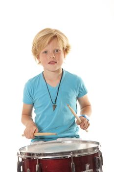 young boy drumming against white background