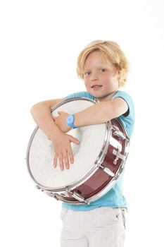 young blond boy holding drum against white background