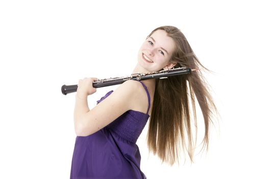girl in purple dress with oboe against white background