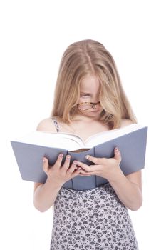 young blond girl with glasses and large book in studio against white background