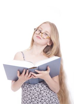 young blond girl with glasses and large book in studio against white background