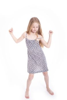 young blond girl dancing in studio against white background