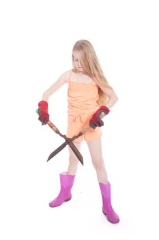 young blond girl with garden shears in studio against white background