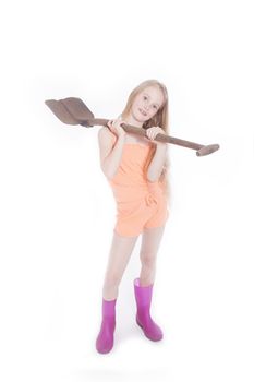 young blond girl standing with shovel in studio against white background