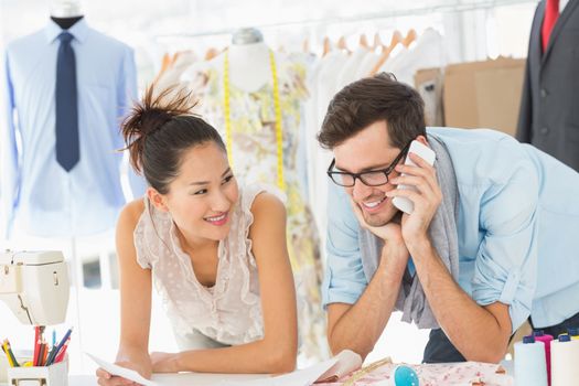 Male and female fashion designers at work in a studio