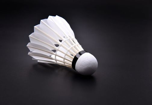new shuttlecock on dark floor