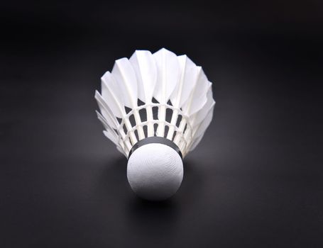 new shuttlecock on dark floor
