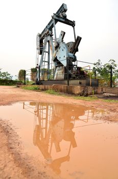 old pumpjack pumping crude oil from oil well